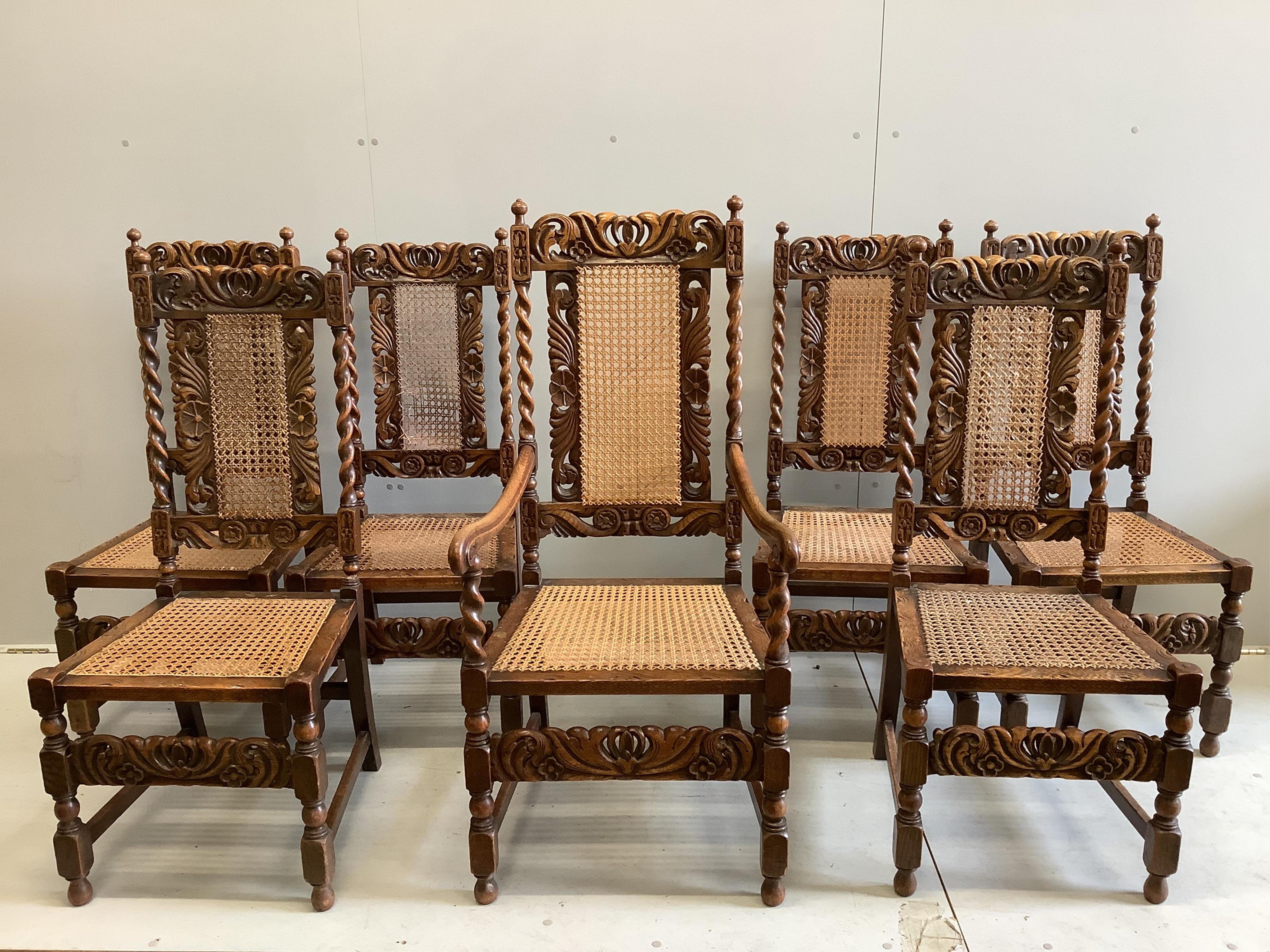 A set of seven Jacobean Revival caned oak dining chairs, one with arms